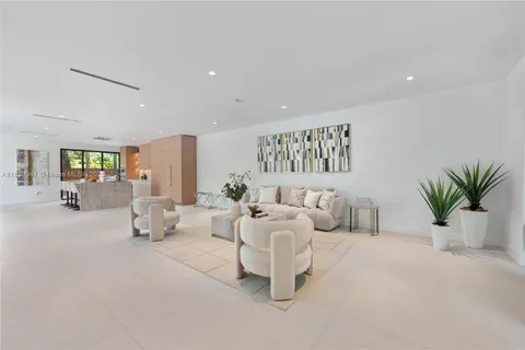 a living room with furniture white walls and white walls