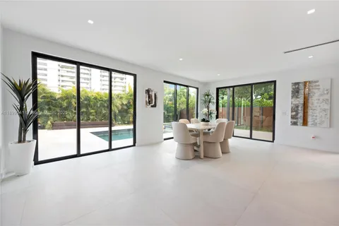 a living room with furniture and a large window with outer view