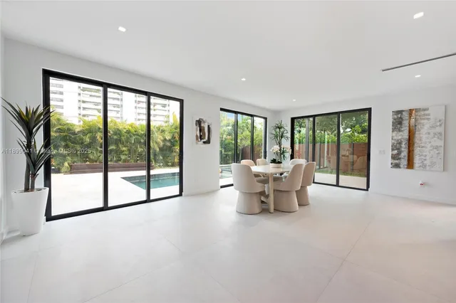 a living room with furniture and a large window with outer view