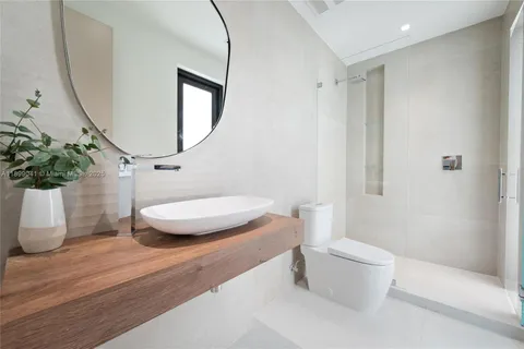 a bathroom with a toilet a sink and a mirror