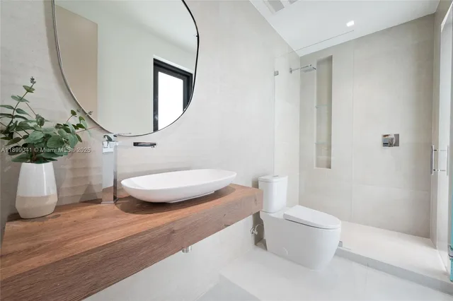 a bathroom with a toilet a sink and a mirror