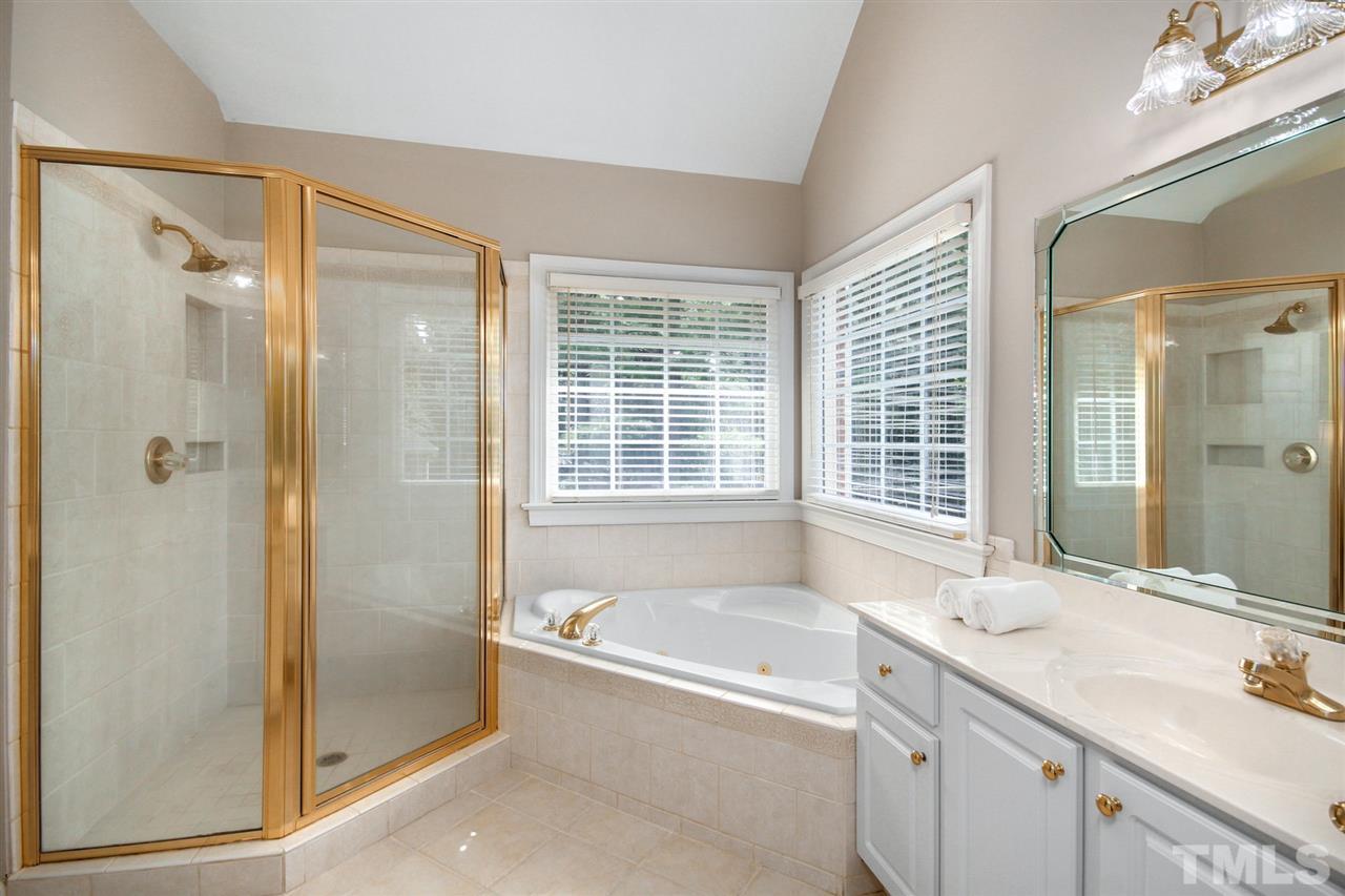 3920 Lauriston Road Raleigh, NC 27616 - Photo 15 of 27 a bathroom with a tub sink shower and a mirror