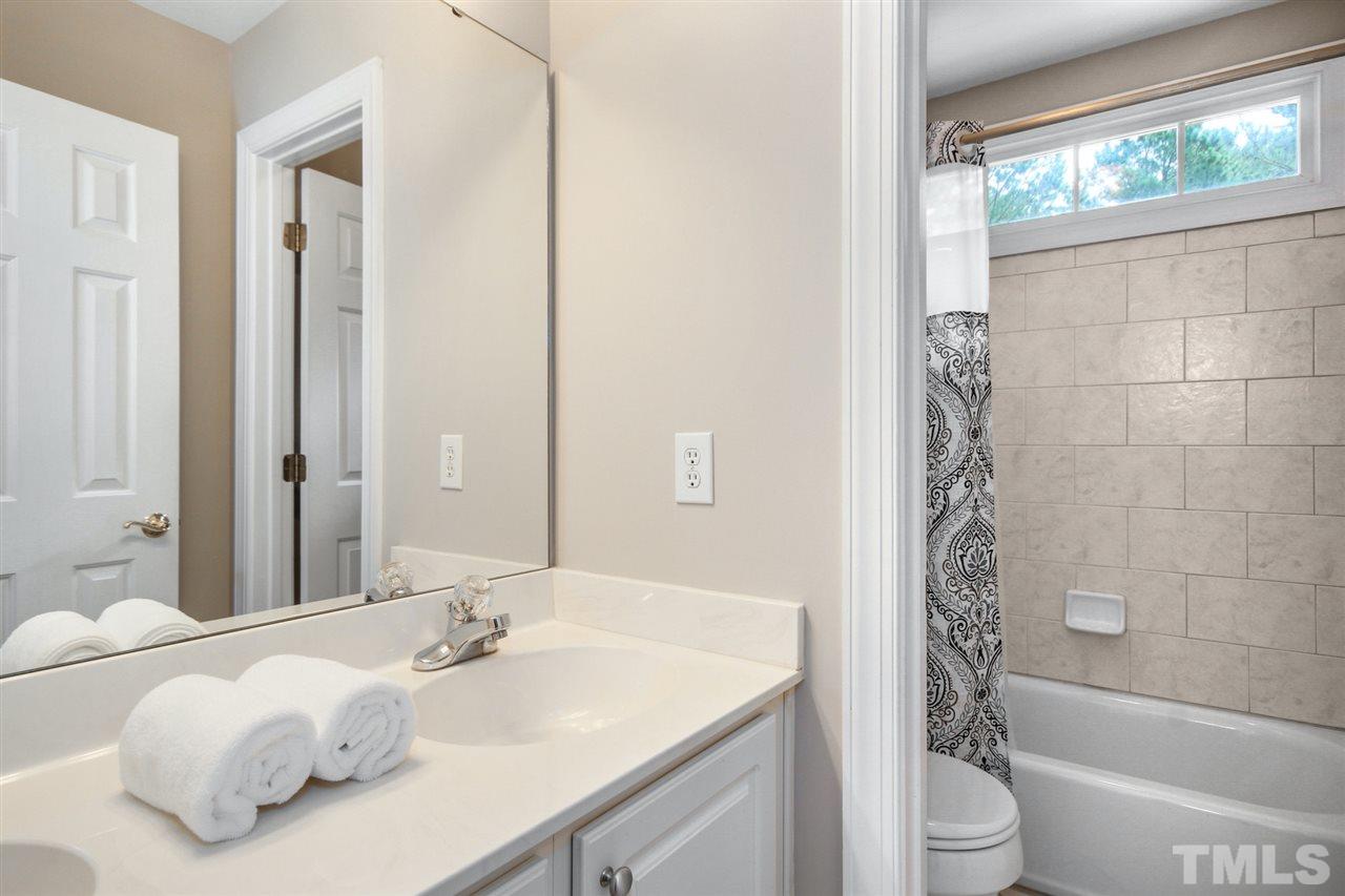 3920 Lauriston Road Raleigh, NC 27616 - Photo 18 of 27 a bathroom with a sink a toilet and shower