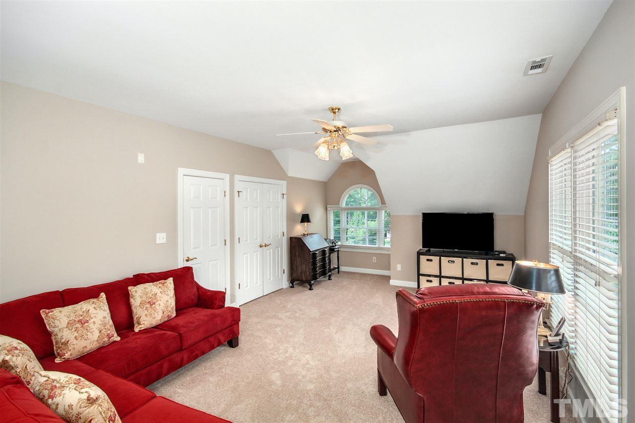 3920 Lauriston Road Raleigh, NC 27616 - Photo 21 of 27 a living room with furniture and a flat screen tv