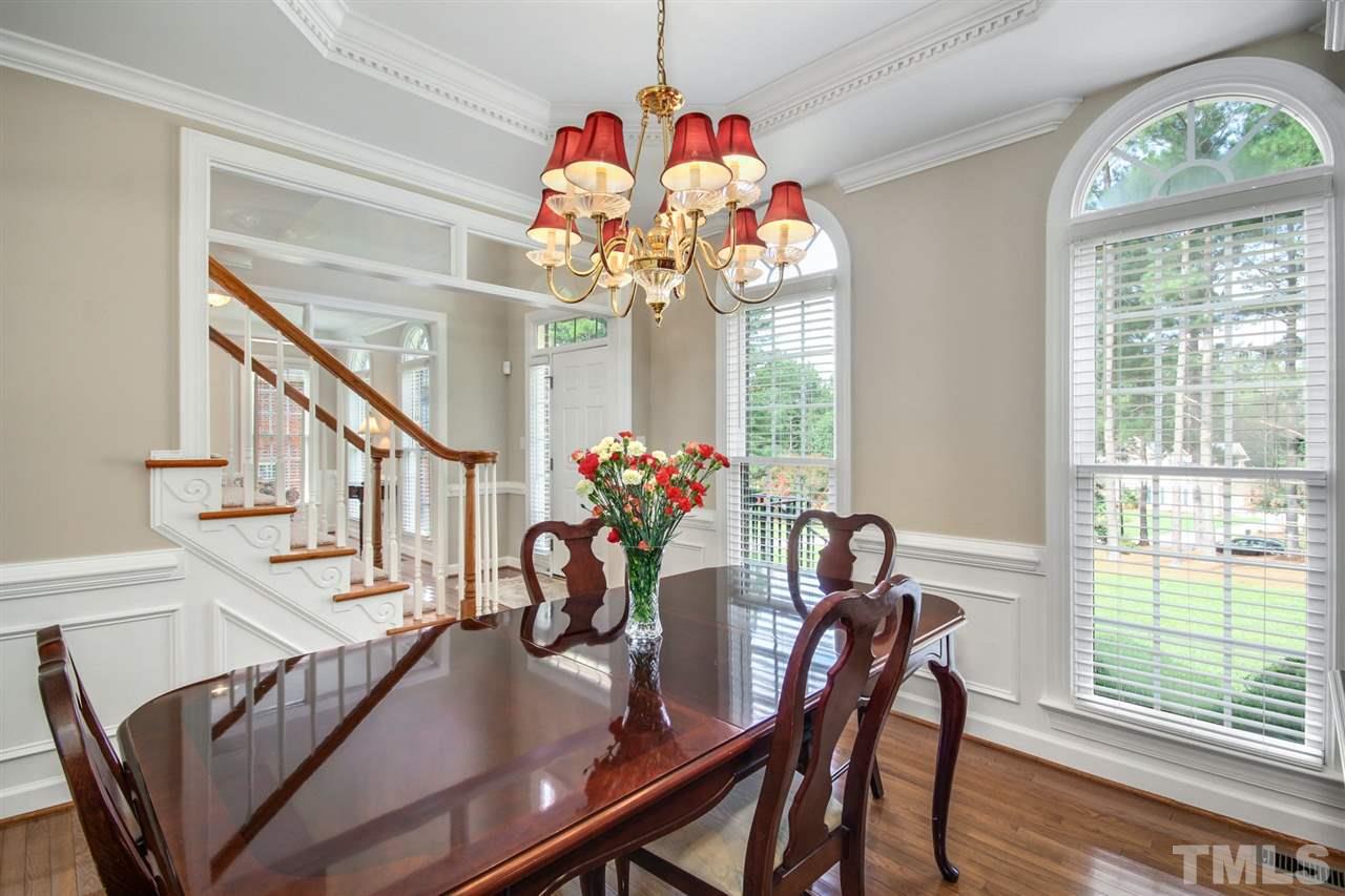 3920 Lauriston Road Raleigh, NC 27616 - Photo 6 of 27 a view of a dining room with furniture a chandelier and wooden floor