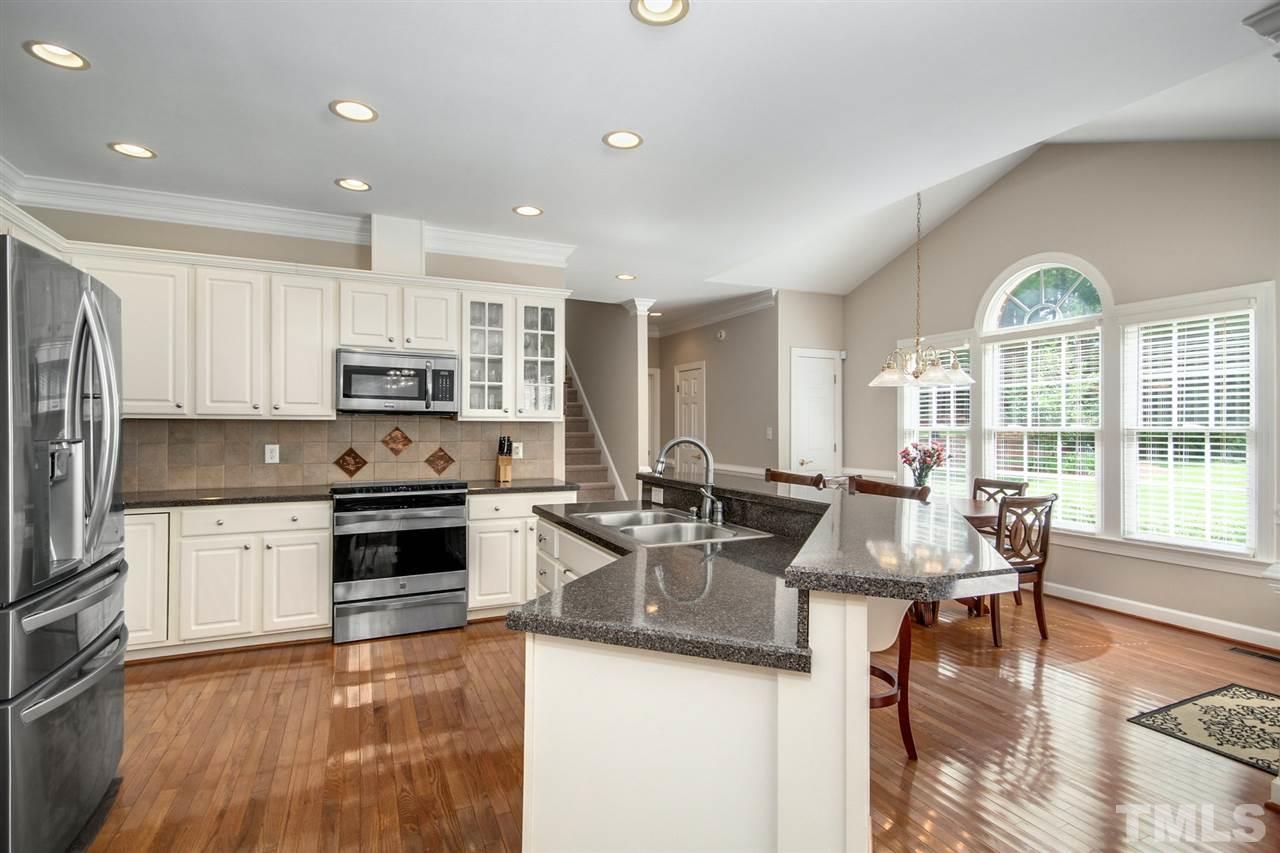 3920 Lauriston Road Raleigh, NC 27616 - Photo 7 of 27 a kitchen with stainless steel appliances granite countertop a stove refrigerator and cabinets