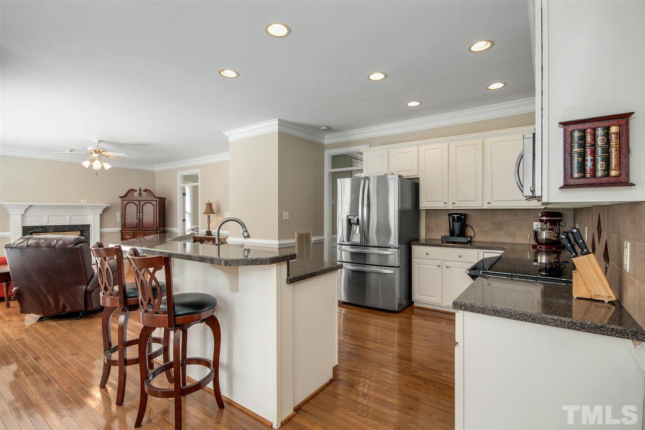 3920 Lauriston Road Raleigh, NC 27616 - Photo 8 of 27 a kitchen with stainless steel appliances granite countertop a refrigerator and a stove top oven