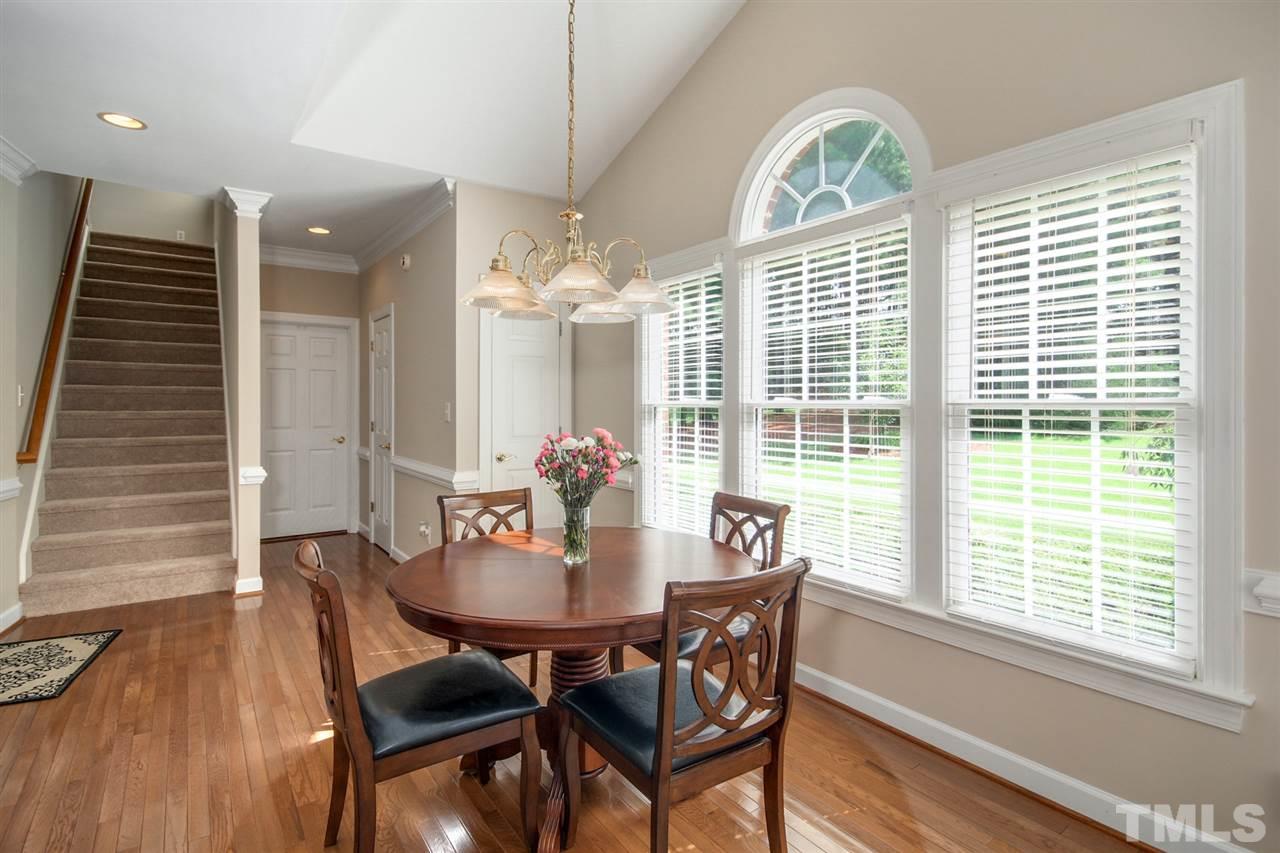 3920 Lauriston Road Raleigh, NC 27616 - Photo 10 of 27 a view of a dining room with furniture a chandelier and wooden floor