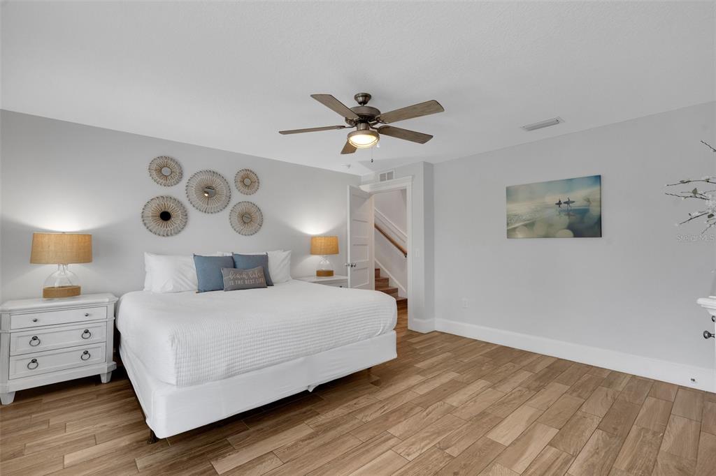 538 Canal Road Sarasota, FL 34242 - Photo 13 of 49 a bedroom with a bed and a chandelier