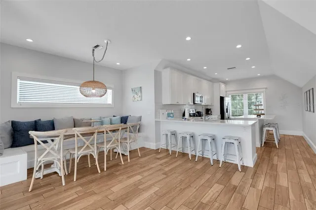 a view of a dining room with furniture window and wooden floor