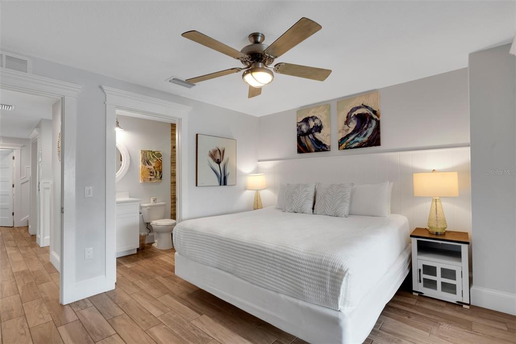 538 Canal Road Sarasota, FL 34242 - Photo 25 of 49 a bedroom with a large bed and a chandelier