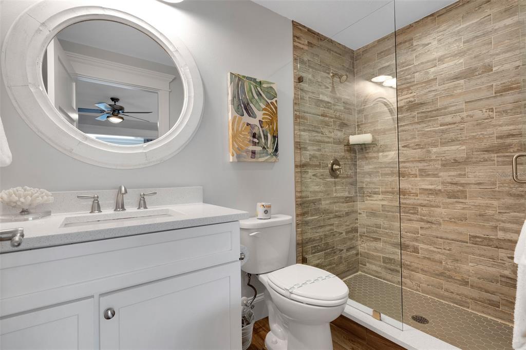 538 Canal Road Sarasota, FL 34242 - Photo 26 of 49 a bathroom with a toilet a sink and mirror