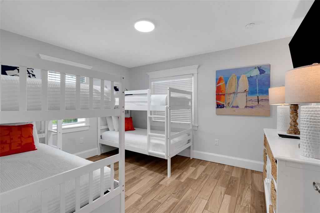 538 Canal Road Sarasota, FL 34242 - Photo 27 of 49 a bedroom with furniture and a wooden floor