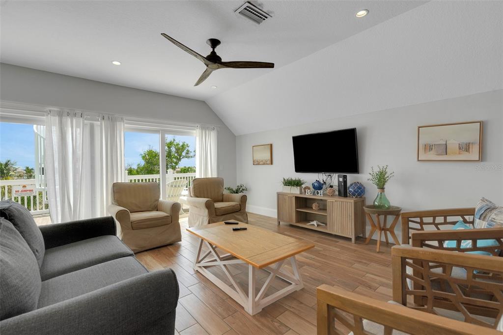 538 Canal Road Sarasota, FL 34242 - Photo 29 of 49 a living room with furniture and a flat screen tv