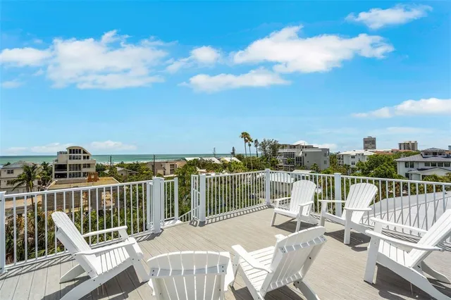 a view of a chair and table on the deck