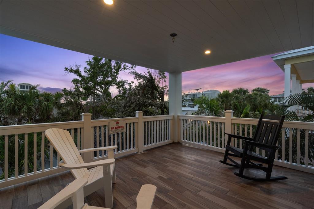 538 Canal Road Sarasota, FL 34242 - Photo 32 of 49 a view of balcony with wooden floor and outdoor seating