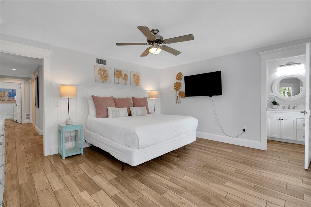 538 Canal Road Sarasota, FL 34242 - Photo 38 of 49 a bedroom with a bed and a flat screen tv