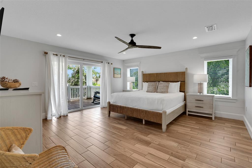 538 Canal Road Sarasota, FL 34242 - Photo 47 of 49 a bedroom with a bed and wooden floor