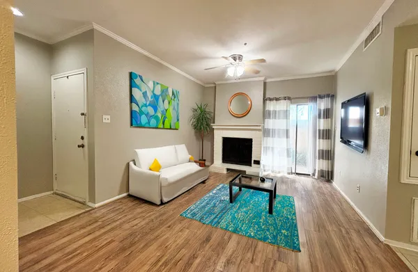 a living room with furniture and a fireplace