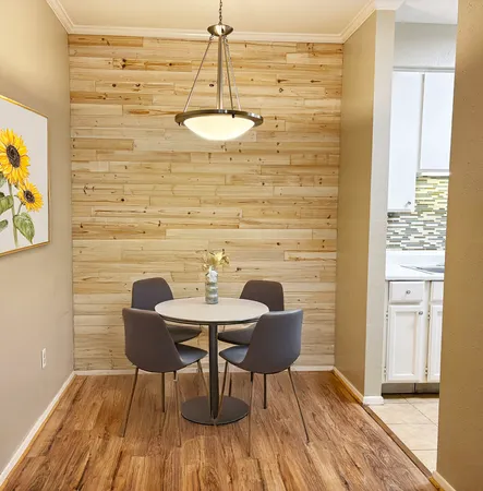a view of a dining room with furniture and wooden floor