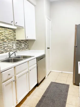 a view of a kitchen with white cabinets