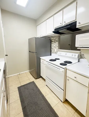 a kitchen with cabinets and appliances