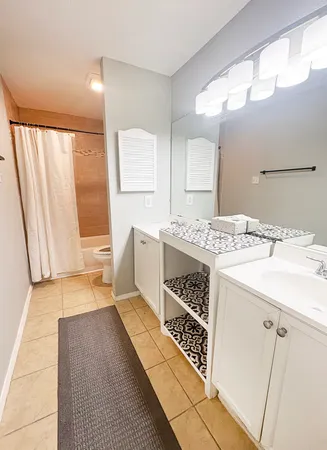 a bathroom with a sink a mirror and a bathtub
