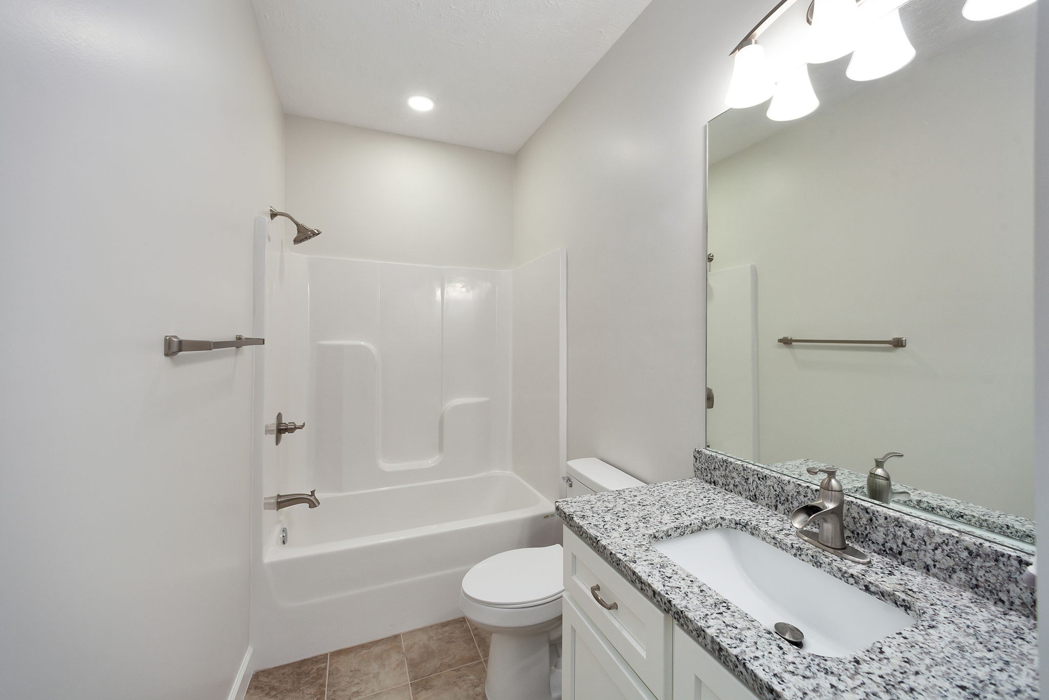 745 Alman Cemetery Road Paris, TN 38242 - Photo 17 of 31 a bathroom with a granite countertop sink a toilet a mirror a bathtub and shower