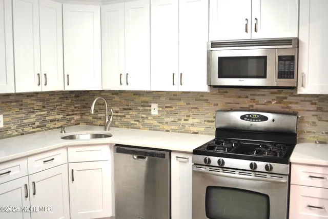 a kitchen with a stove and a microwave