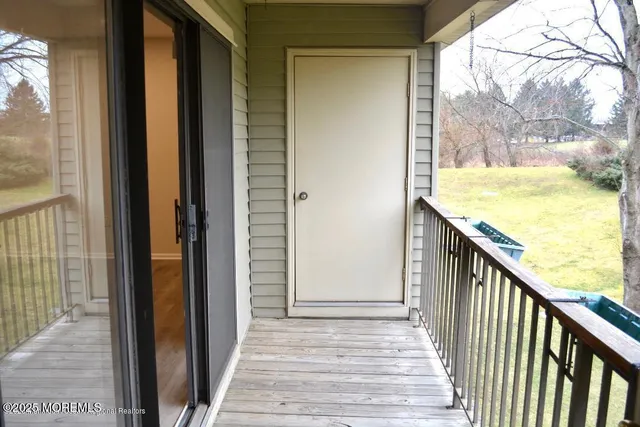 a view of a balcony with wooden floor and outdoor space
