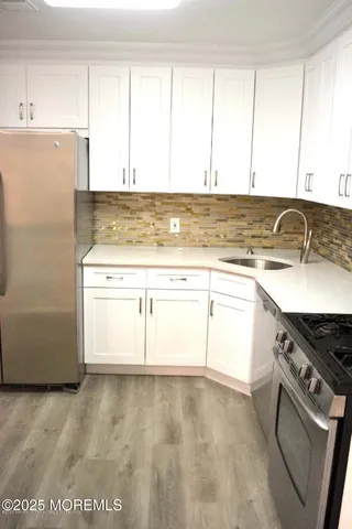 a kitchen with a sink stove and cabinets