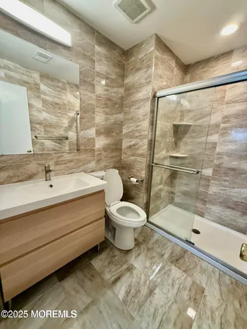 a bathroom with a toilet a sink and shower