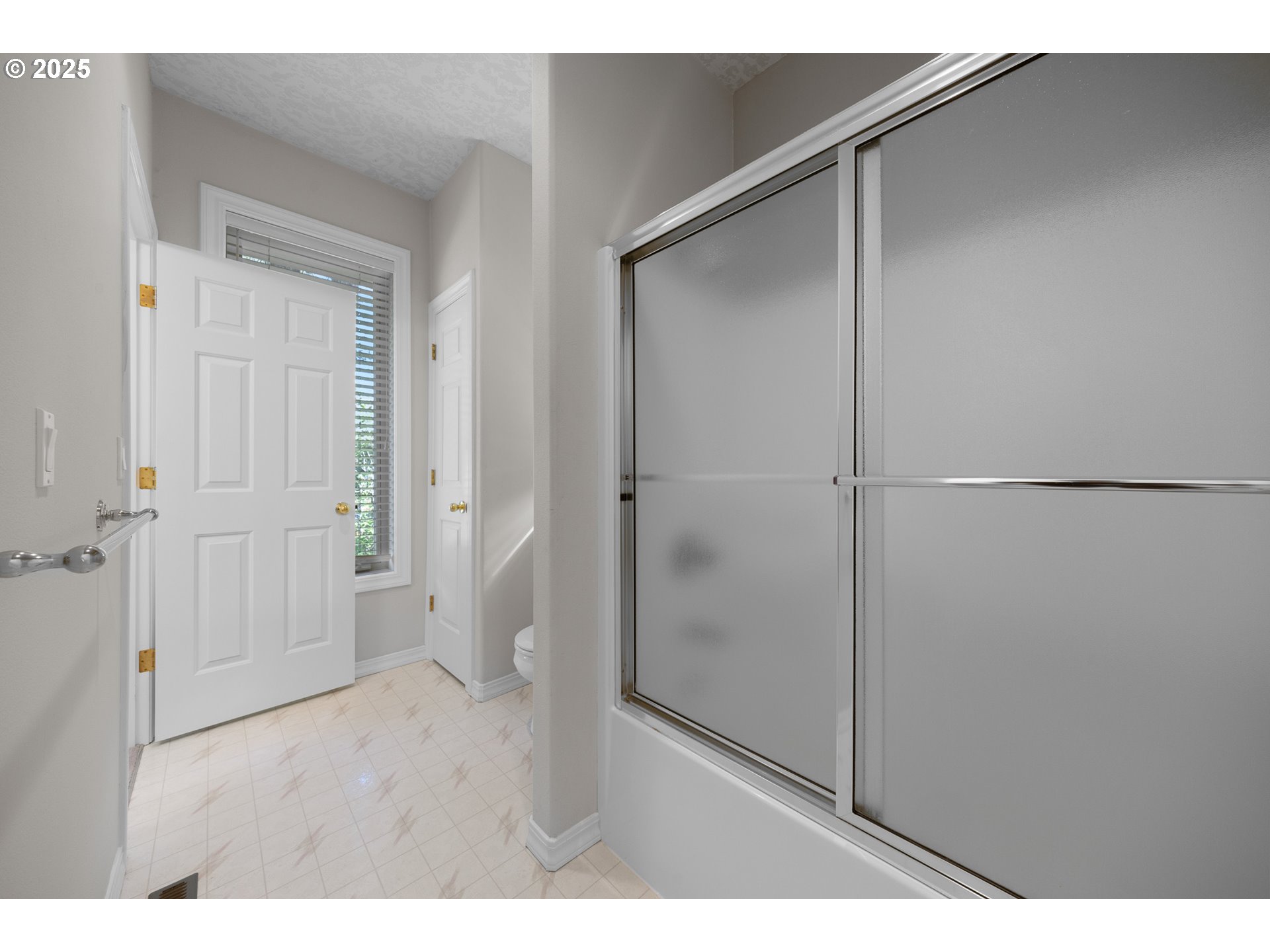 60799 Currant Way Bend, OR 97702 - Photo 18 of 28 a bathroom with a shower and a glass door