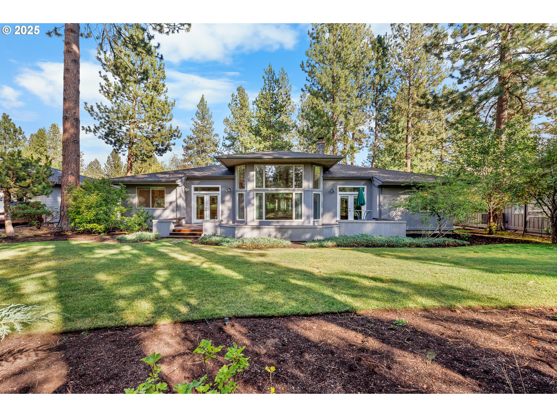 60799 Currant Way Bend, OR 97702 - Photo 2 of 28 a view of a big yard in front of a house
