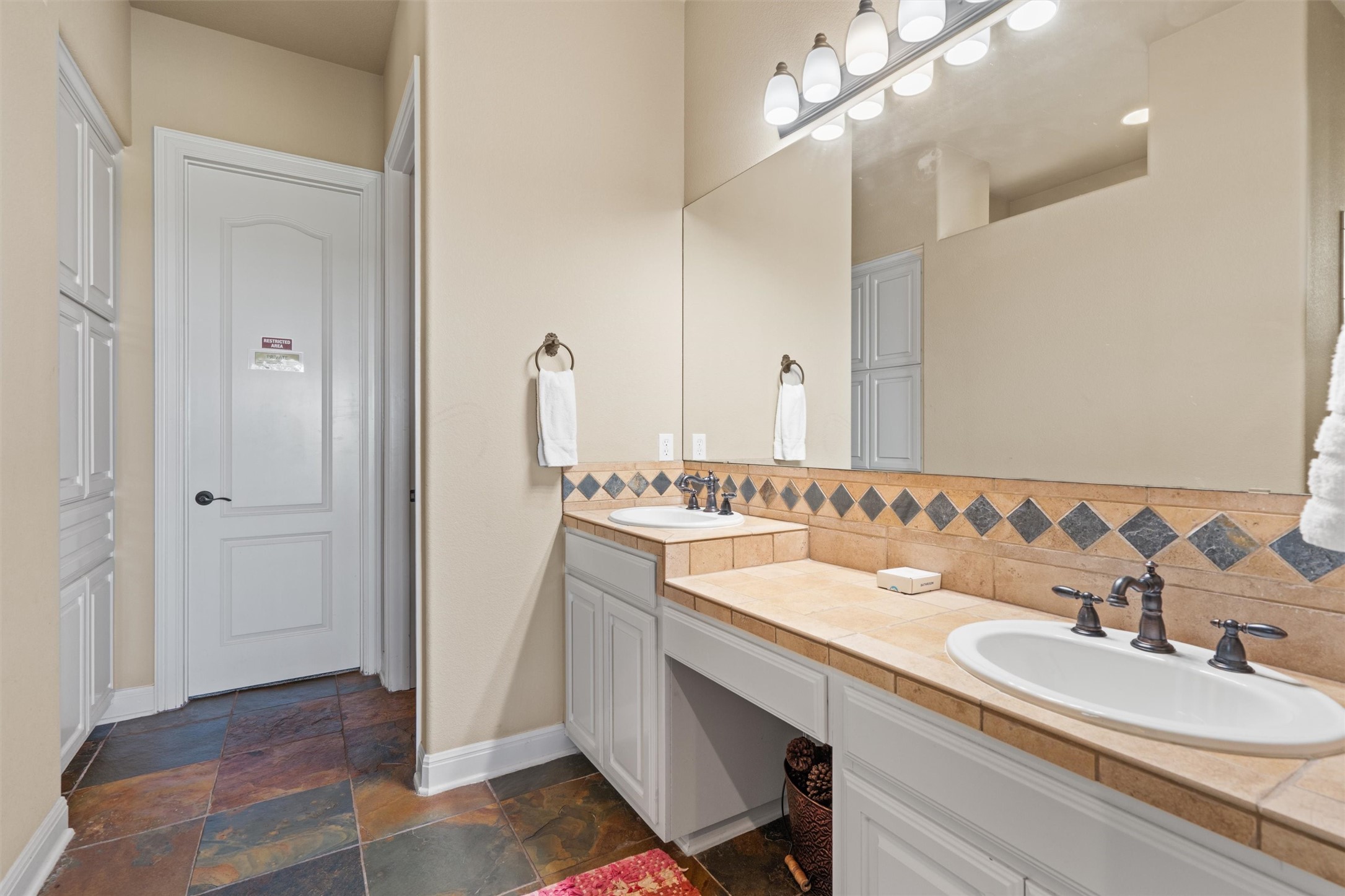 1017 Coventry Road Spicewood, TX 78669 - Photo 15 of 43 a bathroom with a sink double vanity and a mirror