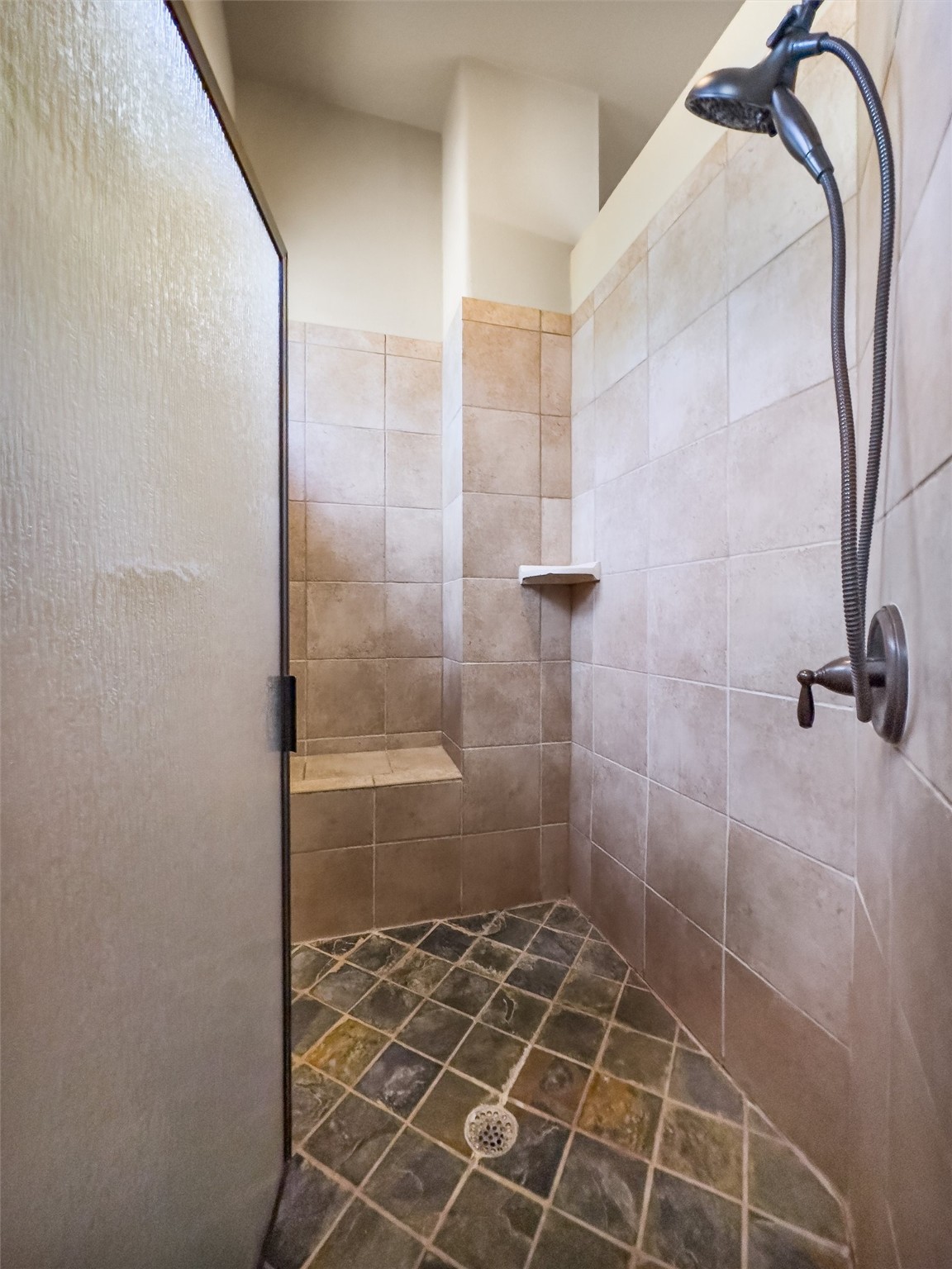 1017 Coventry Road Spicewood, TX 78669 - Photo 16 of 43 a bathroom with a glass shower door