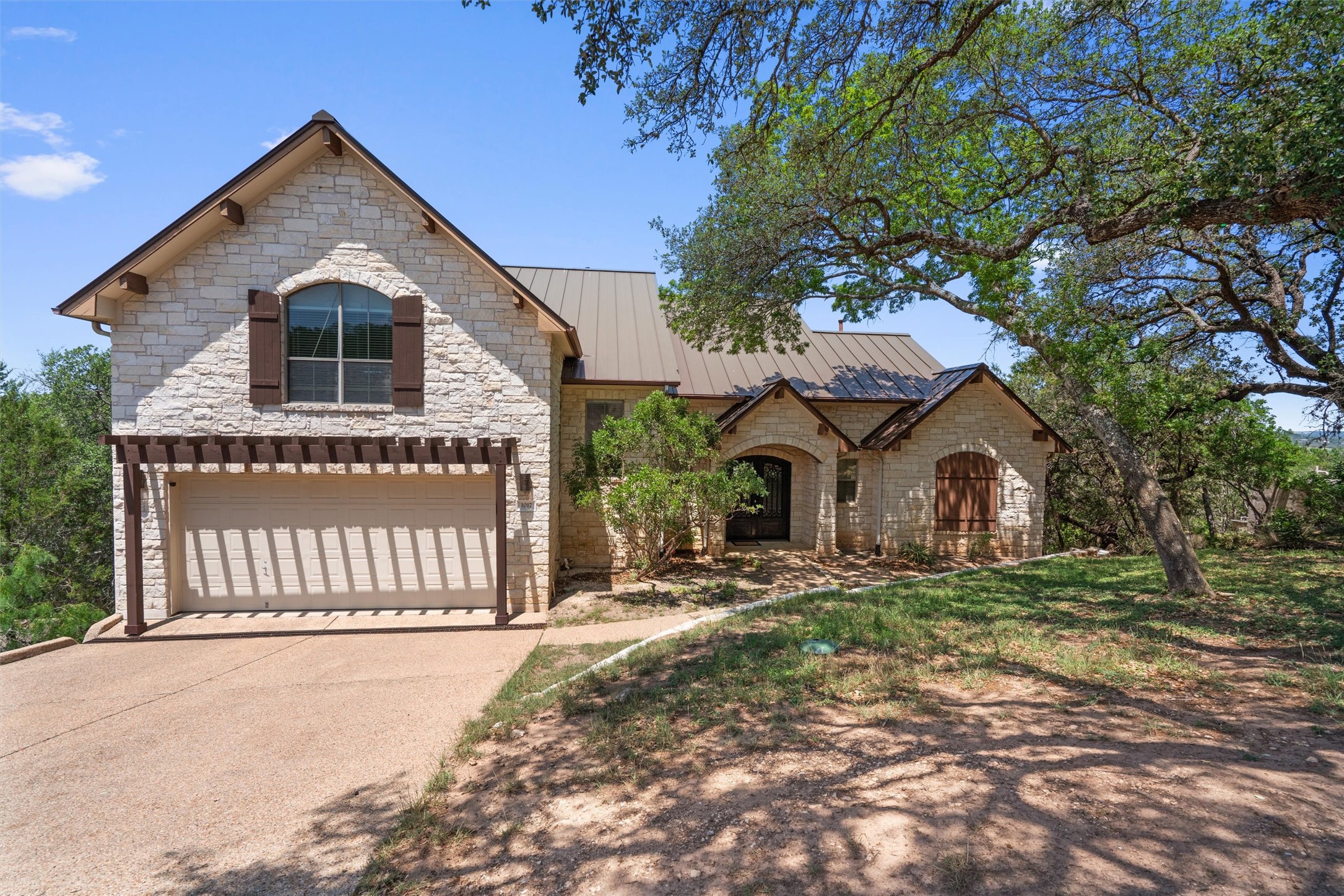 1017 Coventry Road Spicewood, TX 78669 - Photo 2 of 43 a front view of a house with a yard