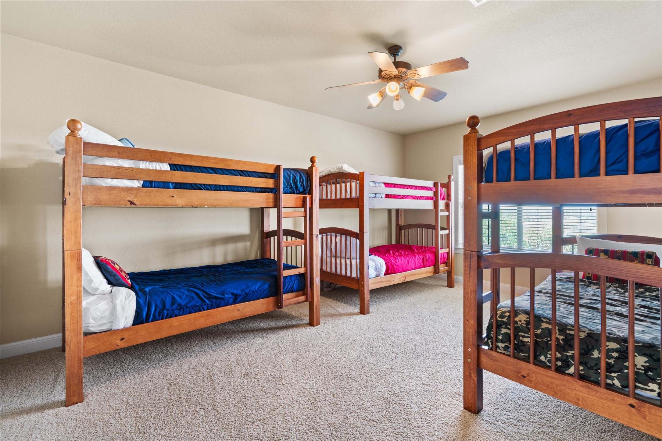 1017 Coventry Road Spicewood, TX 78669 - Photo 28 of 43 a bedroom with bed and a chandelier