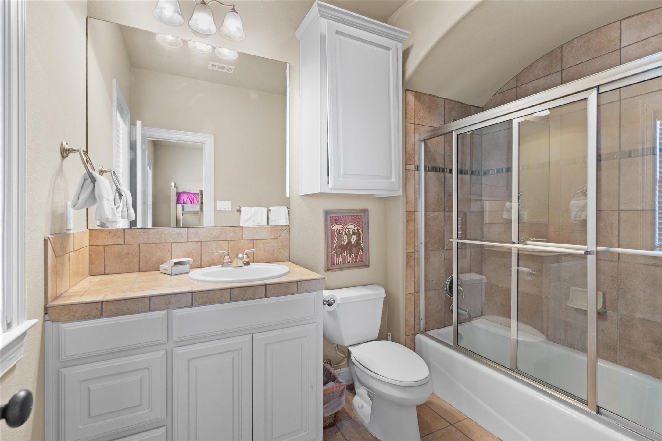 1017 Coventry Road Spicewood, TX 78669 - Photo 30 of 43 a bathroom with a sink toilet and shower