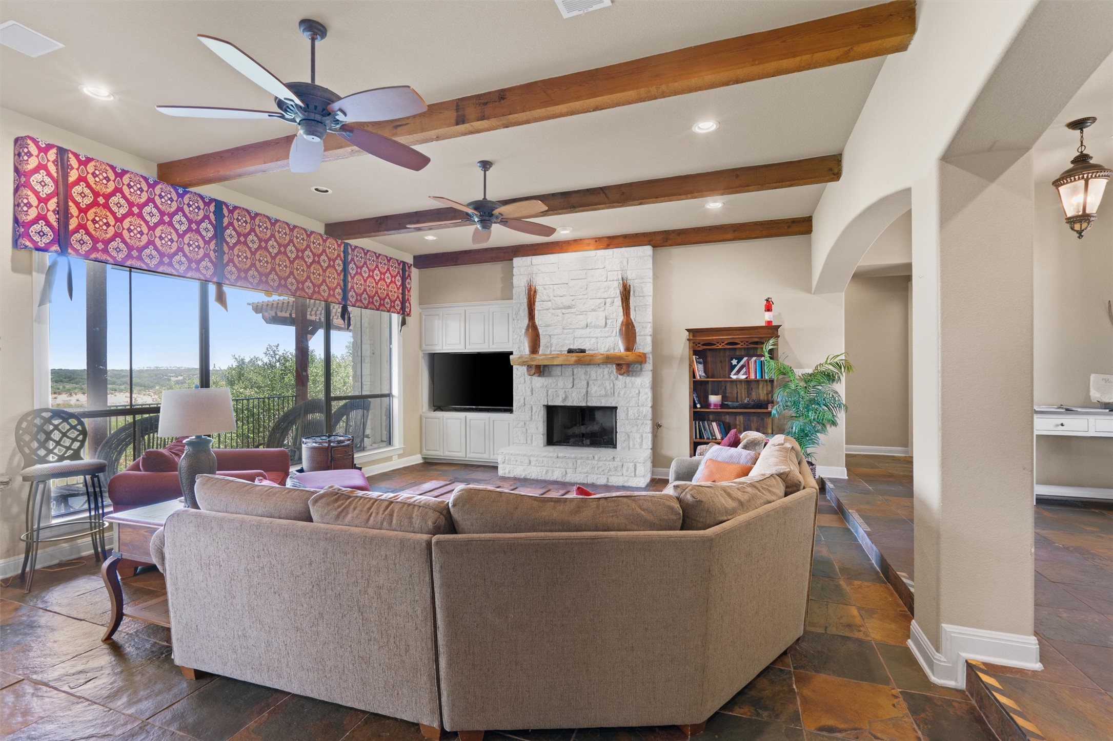 1017 Coventry Road Spicewood, TX 78669 - Photo 5 of 43 a living room with fireplace furniture and a large window