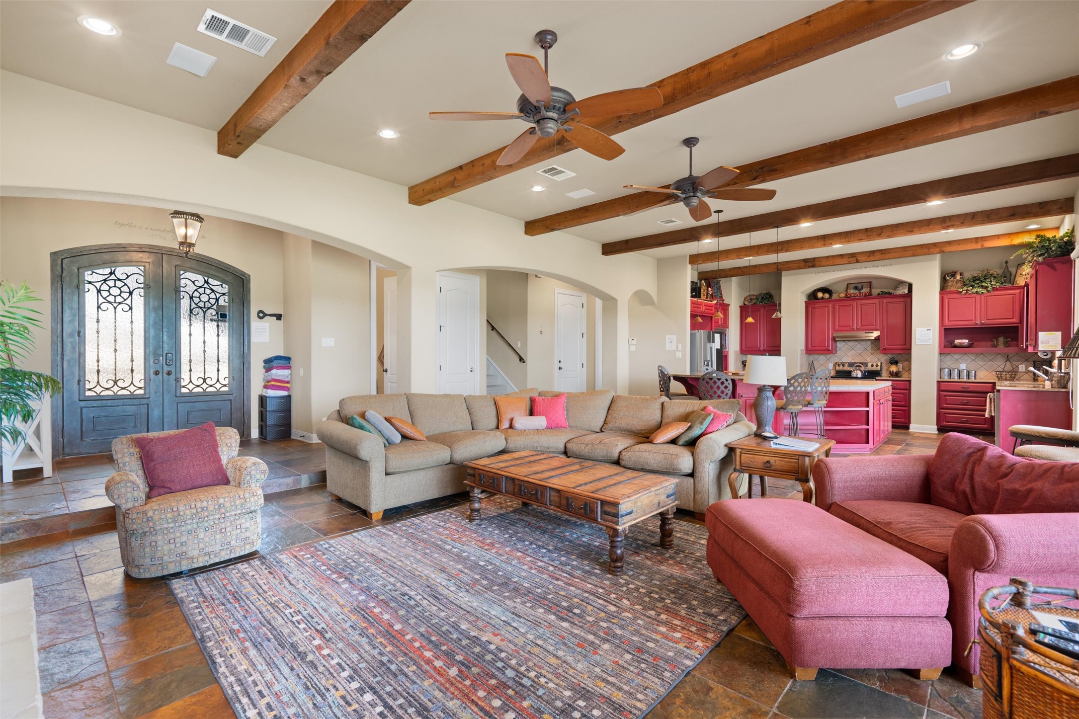 1017 Coventry Road Spicewood, TX 78669 - Photo 7 of 43 a living room with furniture a rug and a chandelier