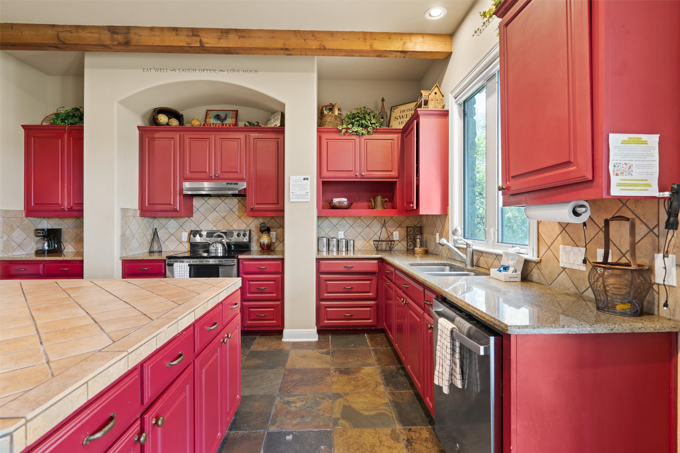 1017 Coventry Road Spicewood, TX 78669 - Photo 10 of 43 a kitchen with kitchen island granite countertop a sink stove and cabinets
