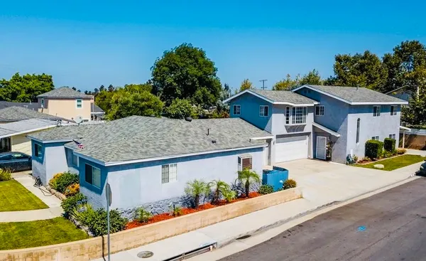 an aerial view of a house with garden space and street view