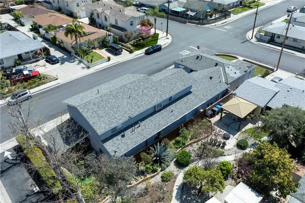 an aerial view of a house with a yard and wooden deck