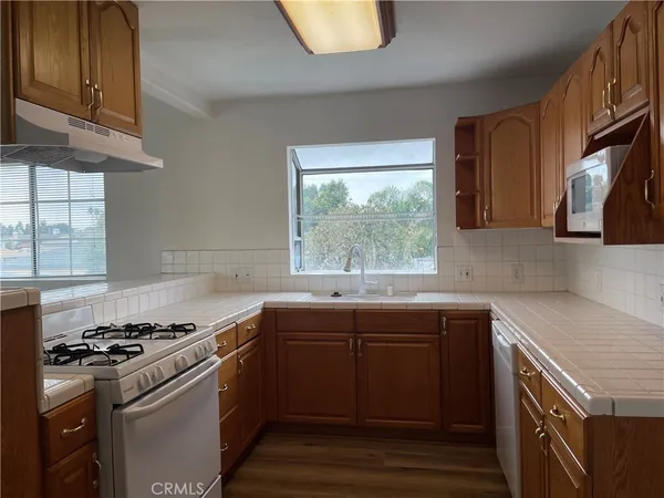 a kitchen with a sink stove top oven and cabinets