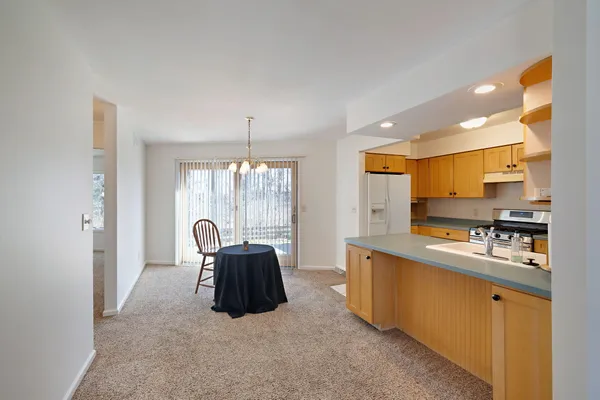 a kitchen with stainless steel appliances granite countertop a sink a stove cabinets and a refrigerator