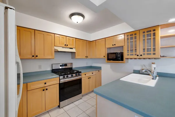a kitchen with a sink a refrigerator and cabinets