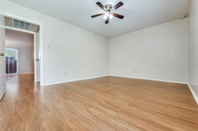 a view of a room with wooden floor