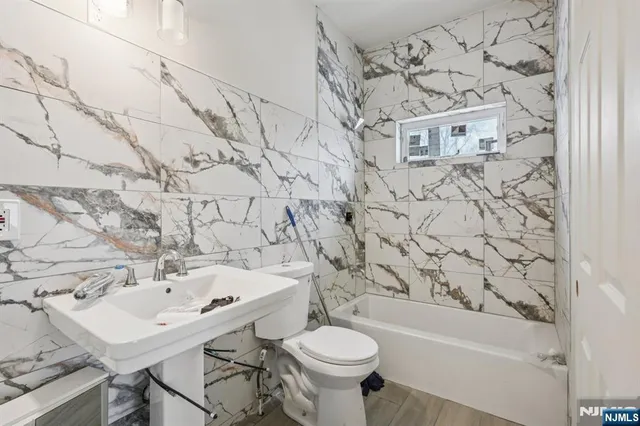 a bathroom with a sink a toilet and a bathtub