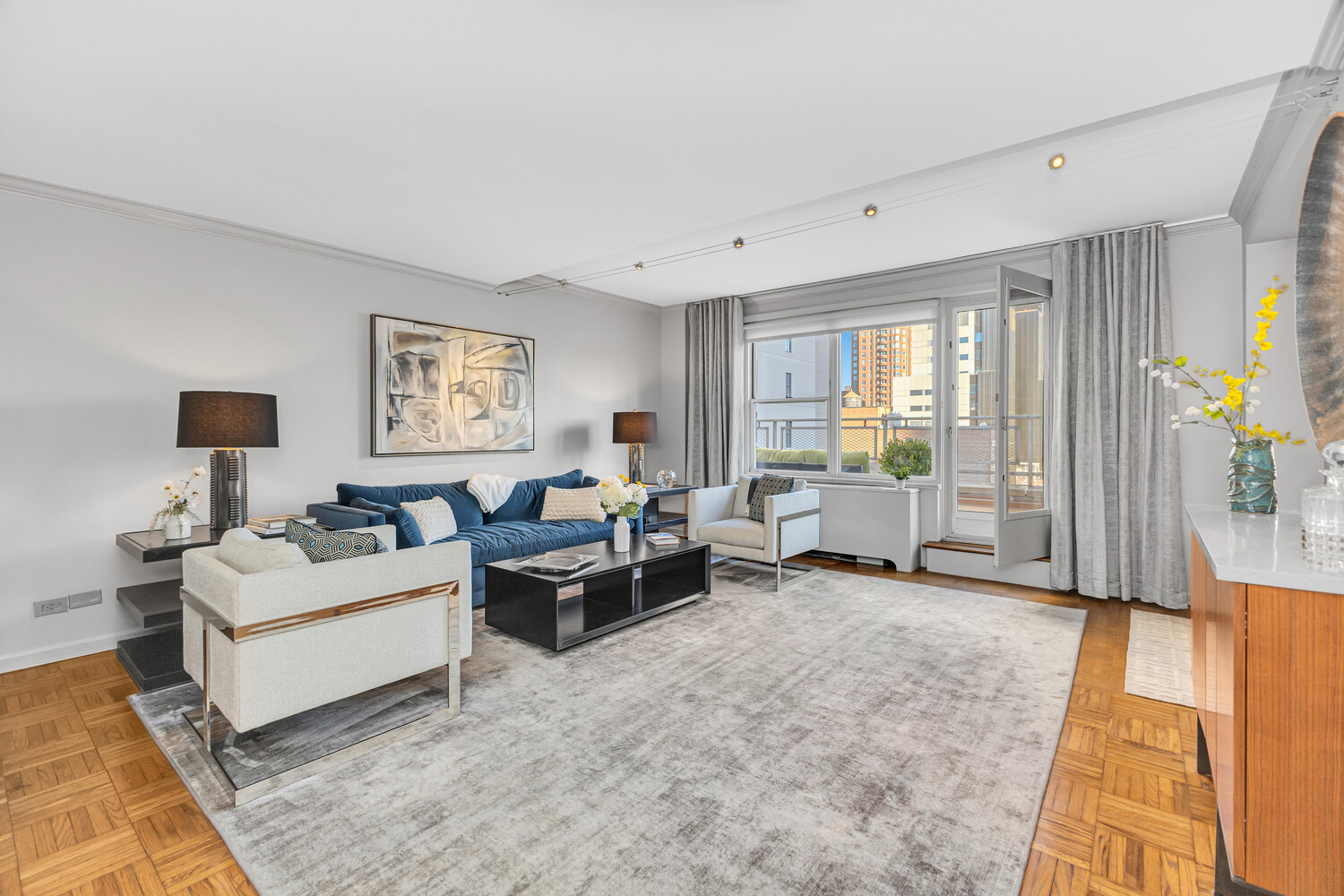 207 East 74th Street, Unit PHG Manhattan, NY 10021 - Photo 4 of 12 a living room with furniture and a large window